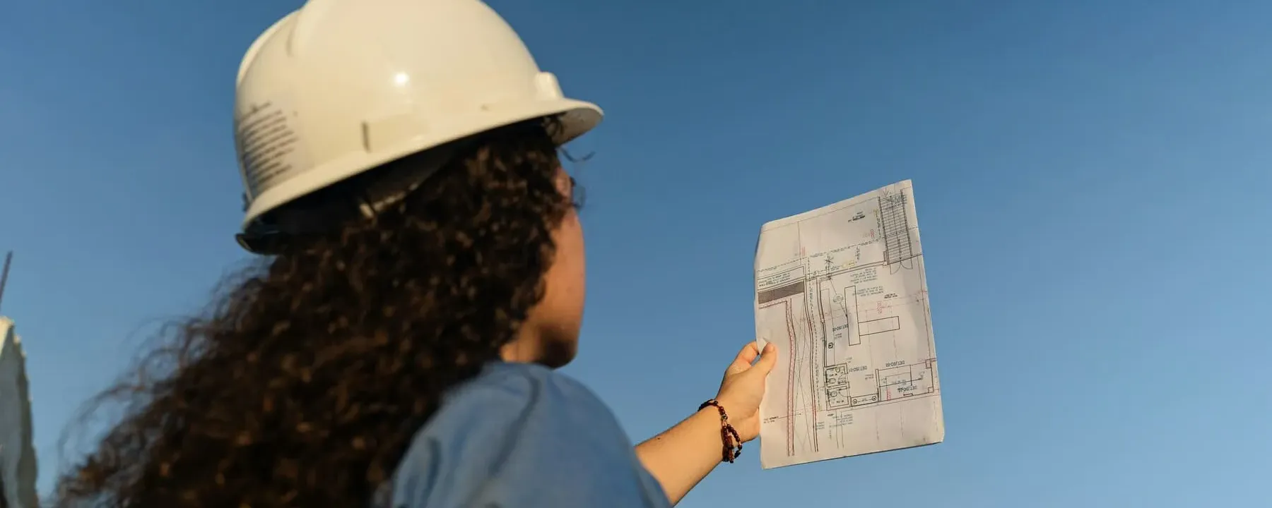 Site engineer reviewing project drawings on a construction site