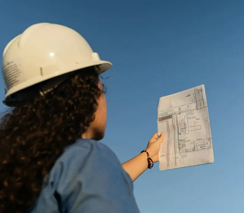 Site engineer reviewing project drawings on a construction site