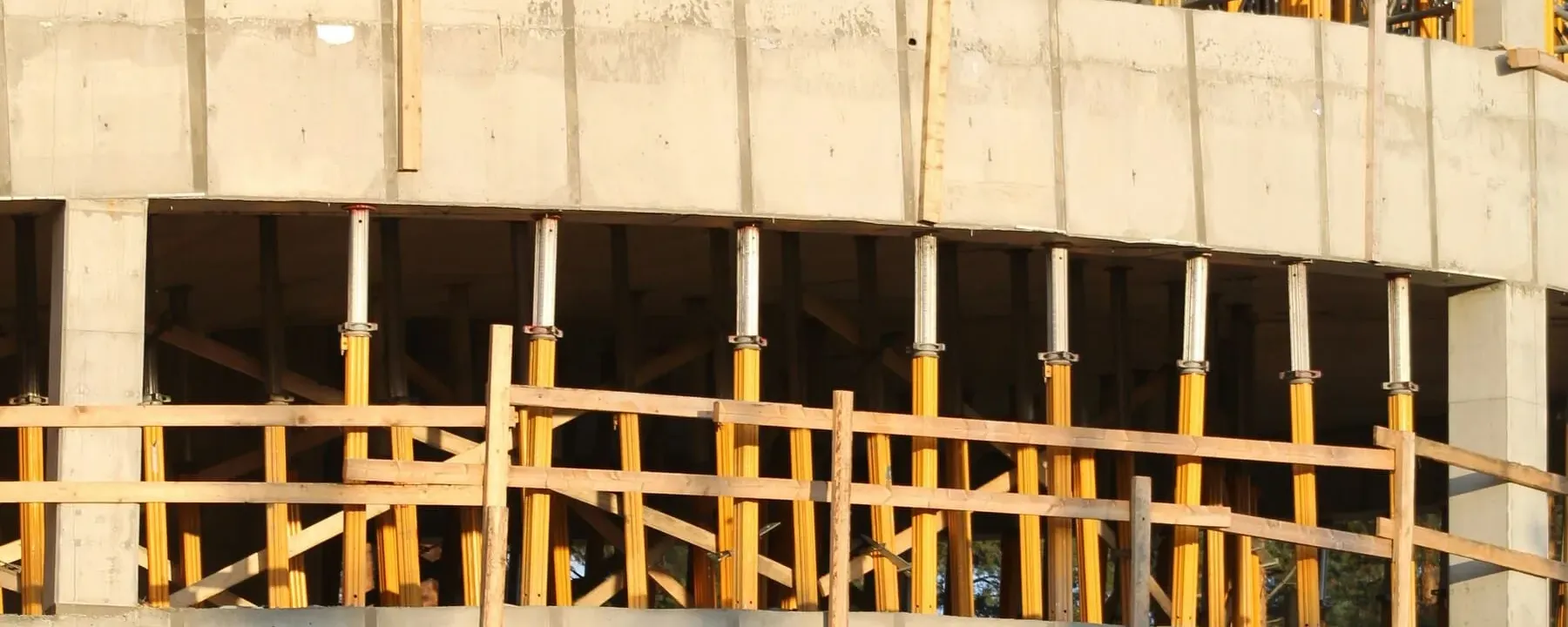 Concrete and formwork structure under construction at golden hour