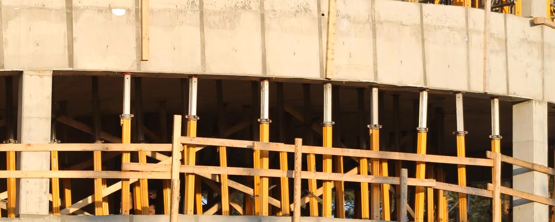 Concrete and formwork structure under construction at golden hour